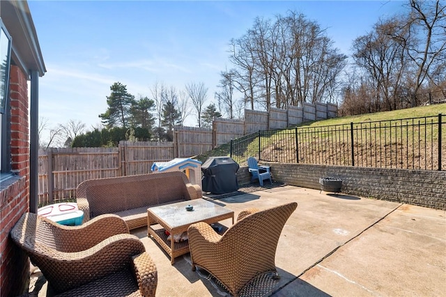 view of patio featuring a fenced backyard and a grill