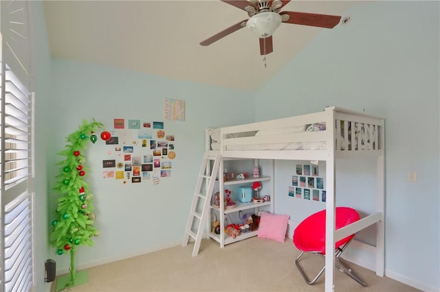 carpeted bedroom with a ceiling fan and vaulted ceiling