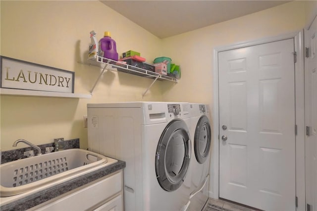 washroom featuring laundry area, independent washer and dryer, and a sink