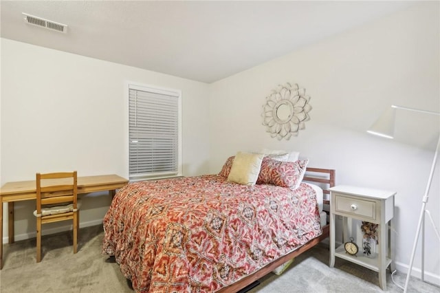 carpeted bedroom with visible vents and baseboards