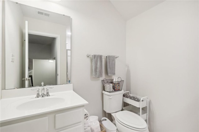 bathroom with visible vents, toilet, and vanity