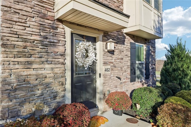 property entrance featuring stone siding