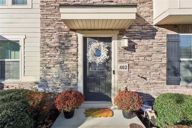 entrance to property featuring stone siding