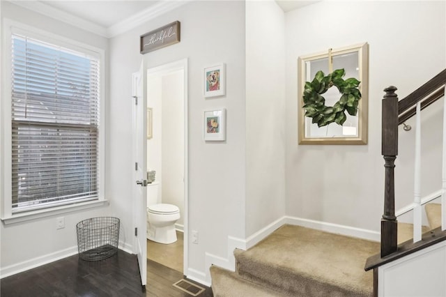 bathroom with visible vents, baseboards, toilet, and wood finished floors