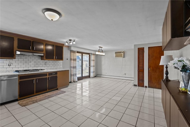 kitchen featuring a baseboard heating unit, tasteful backsplash, appliances with stainless steel finishes, light countertops, and light tile patterned floors