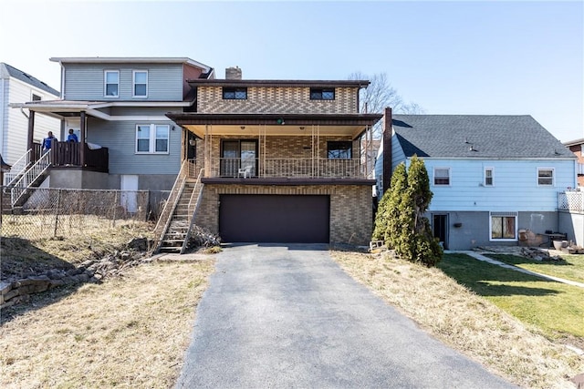 view of front of home featuring a chimney, stairs, a garage, aphalt driveway, and brick siding