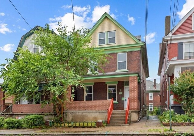 view of front of property with a porch and brick siding