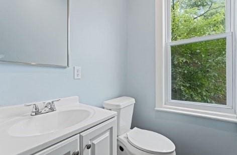 bathroom featuring toilet and vanity