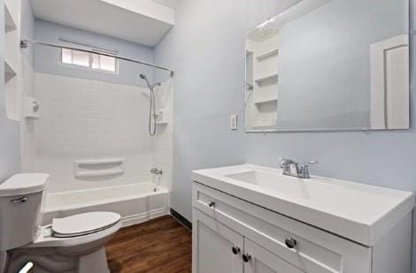 full bath featuring shower / bath combination, toilet, wood finished floors, and vanity