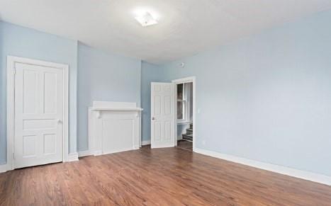 unfurnished bedroom with baseboards and wood finished floors