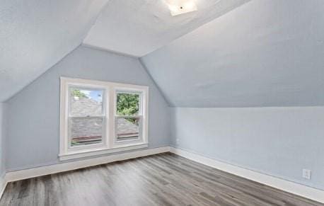 bonus room featuring lofted ceiling, wood finished floors, and baseboards