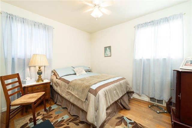 bedroom with ceiling fan and wood finished floors