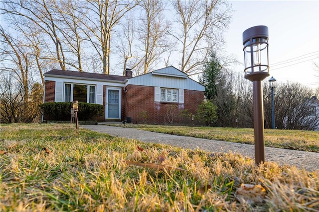 view of front of home featuring brick siding and a chimney