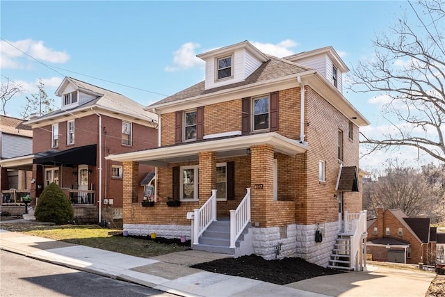 traditional style home featuring brick siding and a porch