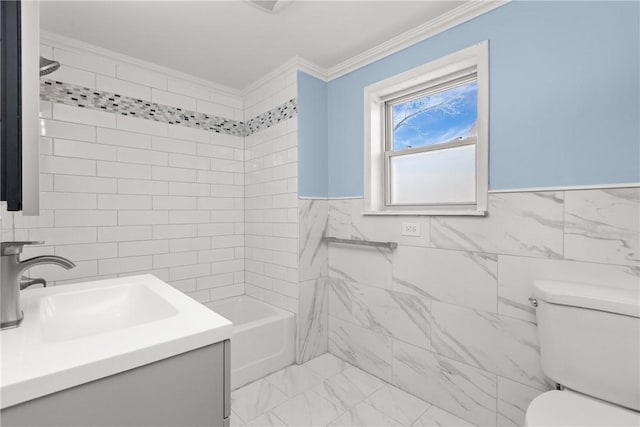 bathroom featuring tile walls, crown molding, toilet, marble finish floor, and vanity