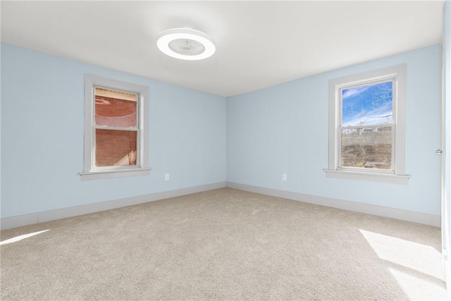 unfurnished room featuring carpet flooring and baseboards