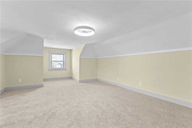 bonus room featuring vaulted ceiling, carpet flooring, and baseboards