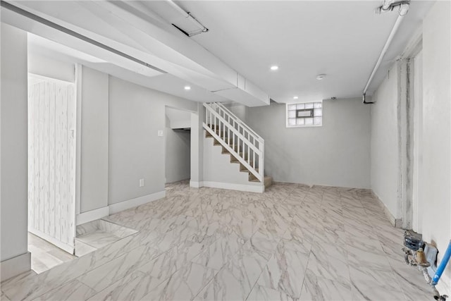 basement featuring marble finish floor, recessed lighting, and stairs