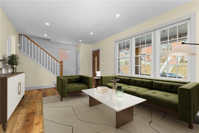 living room with stairs, recessed lighting, baseboards, and wood-type flooring