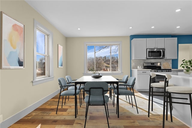 dining space featuring recessed lighting, light wood-type flooring, and baseboards