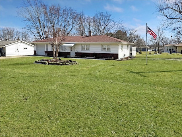 view of front of property with a front yard, a garage, brick siding, and a chimney