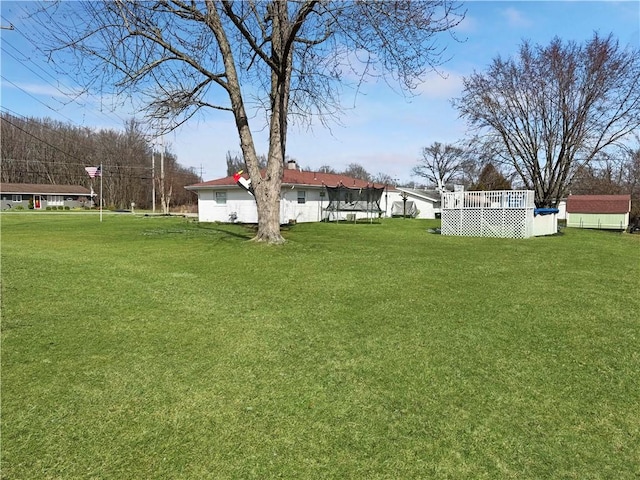 view of yard featuring a shed and an outdoor structure