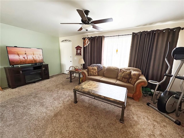 carpeted living area featuring ceiling fan