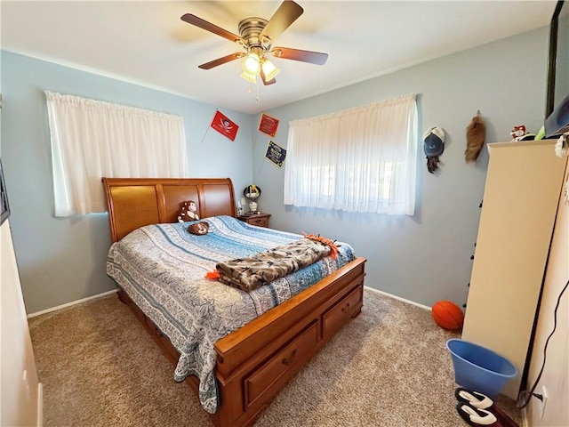 carpeted bedroom with baseboards and ceiling fan