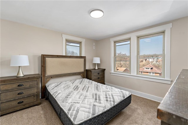 carpeted bedroom featuring baseboards