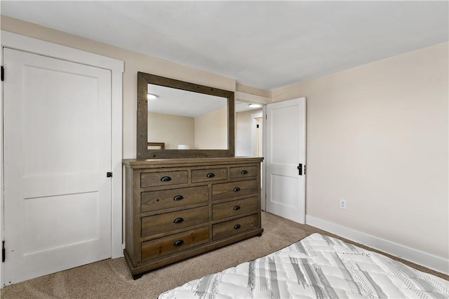 bedroom featuring baseboards and light carpet