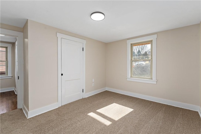 interior space with baseboards and carpet