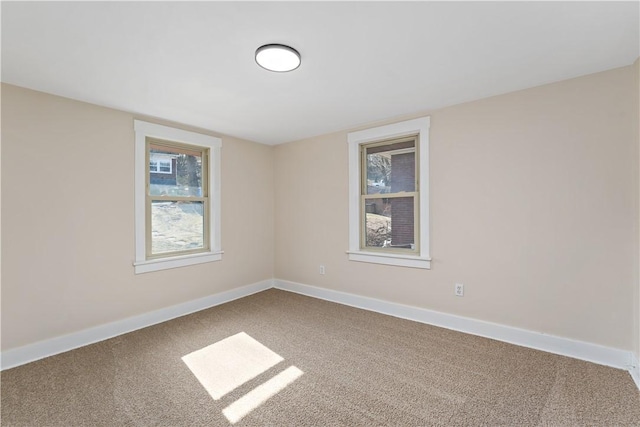 carpeted spare room with baseboards