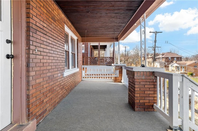 balcony featuring a residential view and covered porch