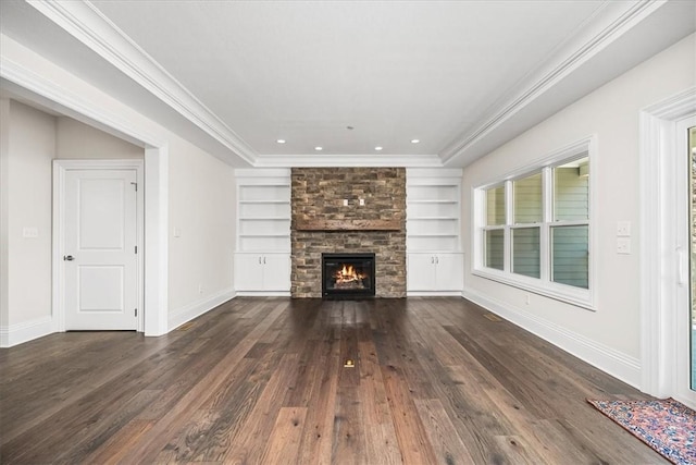 unfurnished living room featuring built in features, baseboards, hardwood / wood-style floors, and crown molding