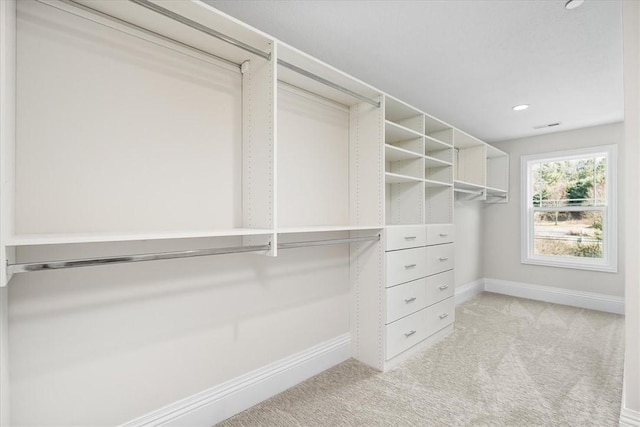 walk in closet with light carpet and visible vents