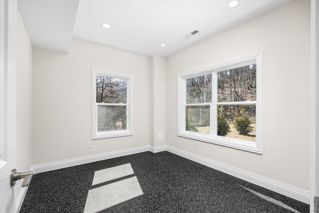 empty room with visible vents, recessed lighting, and baseboards