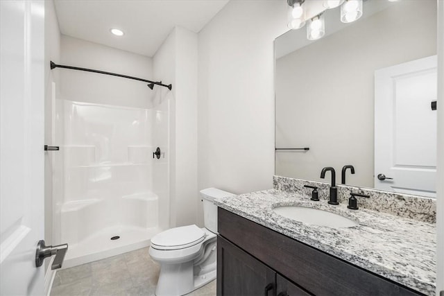 bathroom featuring a shower, toilet, and vanity