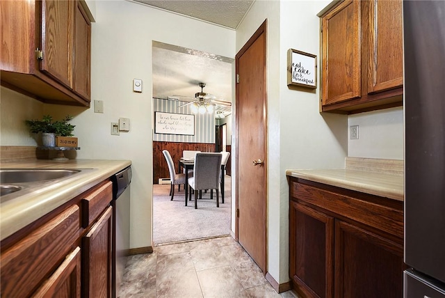 kitchen featuring light countertops, a ceiling fan, appliances with stainless steel finishes, and a textured ceiling