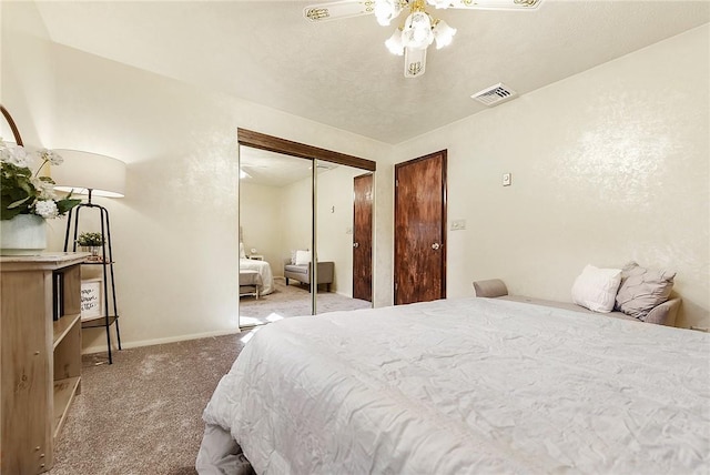 carpeted bedroom featuring a ceiling fan, visible vents, a closet, and baseboards