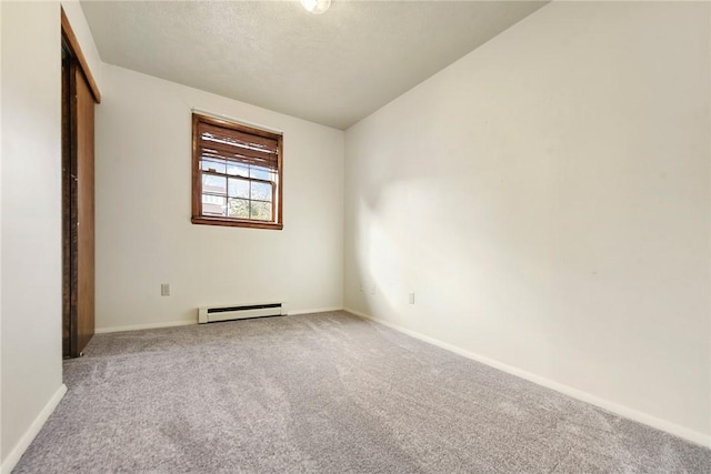 unfurnished bedroom featuring a textured ceiling, a closet, carpet, a baseboard radiator, and baseboards