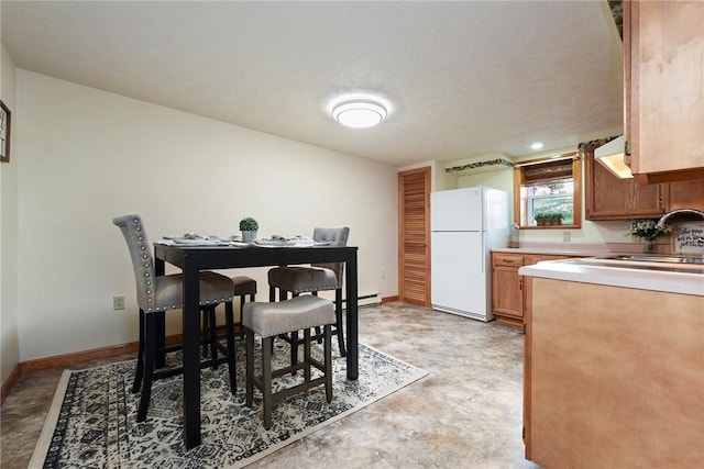 dining room featuring concrete floors and baseboards