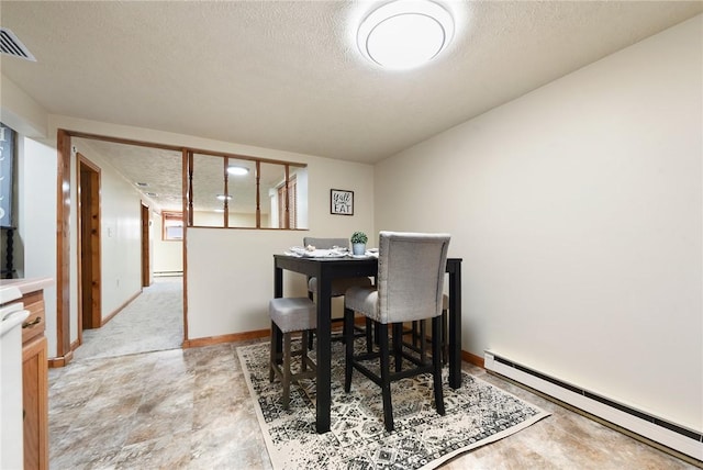 dining room featuring visible vents, a textured ceiling, baseboards, and a baseboard radiator