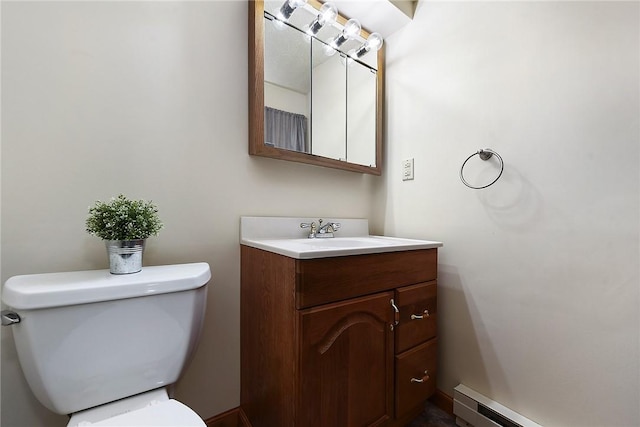 bathroom with a baseboard heating unit, toilet, and vanity