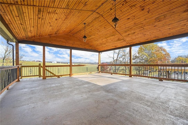 unfurnished sunroom with vaulted ceiling, wood ceiling, and a wealth of natural light