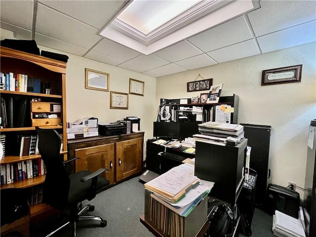 office area with carpet flooring and a paneled ceiling