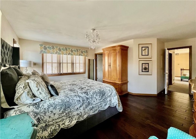 bedroom with dark wood finished floors, baseboards, and an inviting chandelier