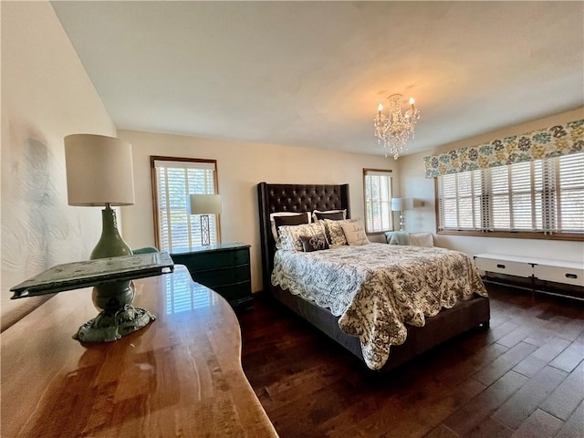 bedroom featuring multiple windows, an inviting chandelier, and dark wood-style floors