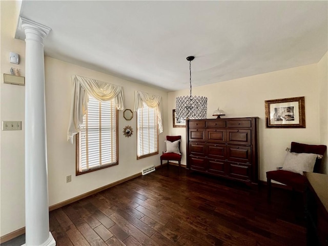 sitting room with decorative columns, baseboards, visible vents, and dark wood-style floors