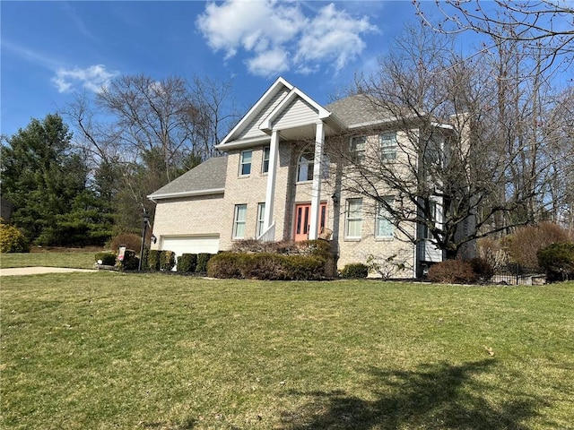 greek revival inspired property featuring a garage and a front yard