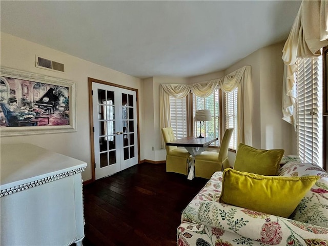 dining room featuring hardwood / wood-style floors, french doors, visible vents, and baseboards